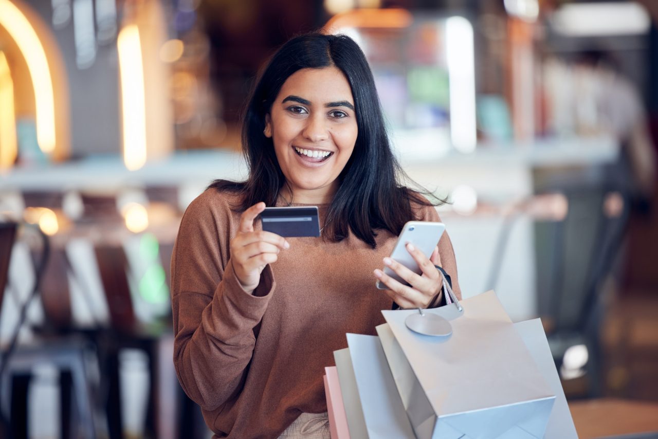 Shot of a young woman making online payments using her smartphone